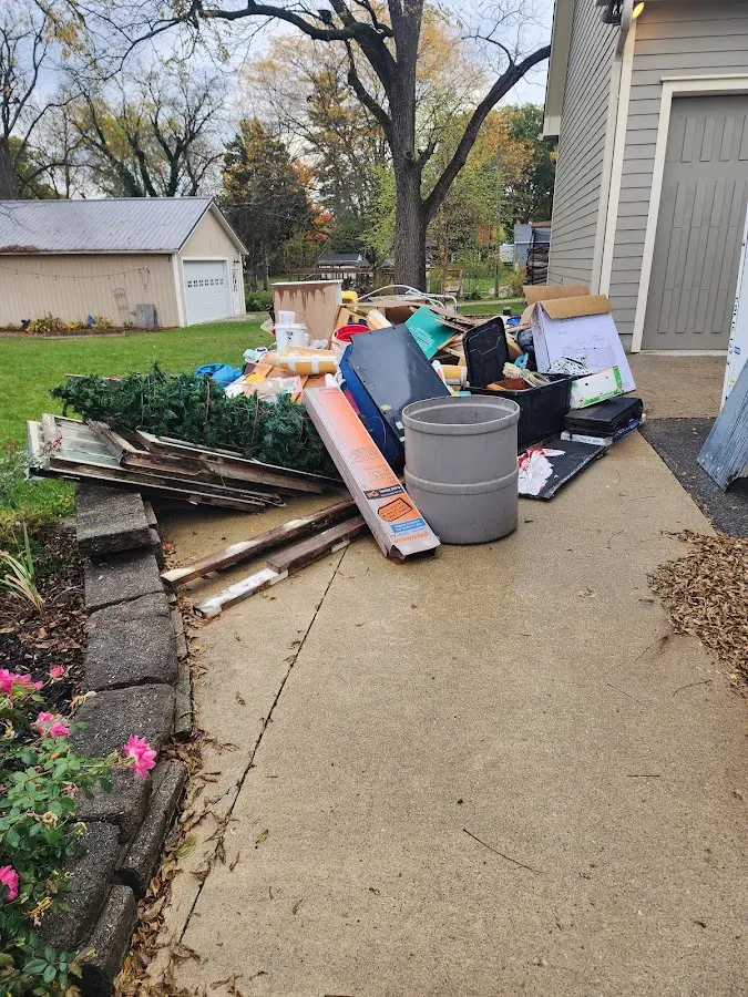 Dumpster being loaded with debris for Estate Cleanout Dumpster Rental in Murphy
